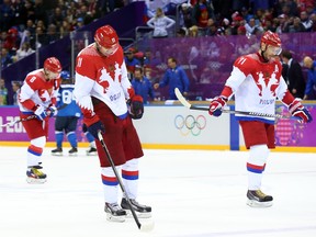 SOCHI: FEBRUARY 19, 2014 --Alexander Ovechkin (L), Yevgeni Malkin and Ilya Kovalchuk of Russia show their dejection after being eliminated by Finland in the quarterfinal match at the Sochi 2014 Olympic Games, February 19, 2014. Photo by Jean Levac/Postmedia News