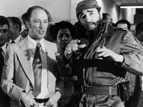 Former prime minister Pierre Trudeau looks on as Cuban President Fidel Castro gestures during a visit to a Havana housing project in this Jan. 27, 1976 photo.