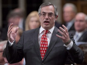 Treasury Board President Tony Clement responds to a question during question period in the House of Commons in Ottawa on Dec. 4, 2014. The Conservative cabinet minister responsible for freedom of information says some federal data cannot be released to the public in electronic format because people might alter it and spread falsehoods. Treasury Board President Tony Clement says there's a fear people could "create havoc" by changing the statistical information.