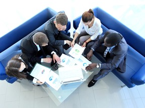 aatop_view_of_working_business_group_sitting_at_table