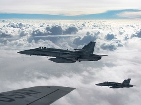 Royal Canadian Air Force CF-18 Hornets depart after refuelling with a KC-135 Stratotanker, over Iraq, in 2014.