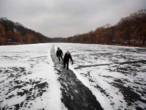 A couple skates along a path in the snow on Grenadier Pond in Toronto's High Park on December 29, 2010.