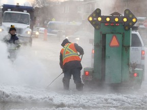 Montreal city crews try to clean up frozen water on Provost Street at 7th Avenue, following a water main break in Lachine, Tuesday February 17, 2015.