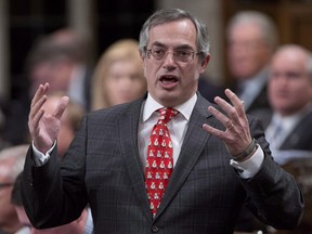 Tony Clement responds to a question during question period in the House of Commons in Ottawa on December 4, 2014.