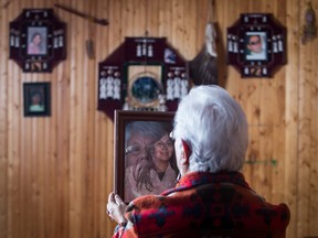 OHSWEKEN, FEB 17, 2015 — MURDERED/MISSING — Aileen Joseph poses with a portrait of her slain daughter Shelley, in her Ohsweken home on February 17, 2015. Shelly Joseph was beaten to death in her Hamilton apartment in 2004. Aileen may be attending a national round table on Murdered and Missing Indigenous Women in Ottawa on February 27, 2015. Glenn Lowson photo for National Post