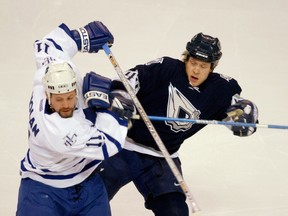 Edmonton Oiler Janne Niinimaa hits Toronto's Owen Nolan during the first period.