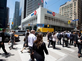 Pedestrians walk in Toronto's financial district.