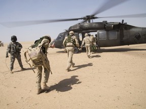 Royal Canadian Air Force members participate in  a combat search and rescue exercise at a training base in Kuwait as part of the Canadian mission against ISIS.