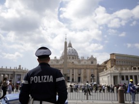A police officer patrols outside St. Peter's Square, in Rome Friday, April 24, 2015. Islamic extremists suspected in a bomb attack in a Pakistani market that killed more than 100 people had also planned an attack against the Vatican in 2010 that was never carried out, an Italian prosecutor said Friday. Wiretaps collected as part of investigation into an Islamic terror network operating in Italy gave "signals of some preparation for a possible attack" at the Vatican, prosecutor Mauro Mura told a news conference in Cagliari, Sardinia. (AP Photo/Gregorio Borgia)