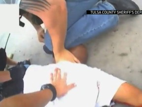 In this screen shot from April 2, 2015 video provided by the Tulsa County Sheriff's Office, police restrain 44-year-old Eric Harris after he was chased down and tackled by a Tulsa County Deputy, and then shot by a reserve sheriff's deputy while in custody, in Tulsa, Okla. The sheriff's office said 73-year-old reserve deputy Robert Charles Bates fired the shot that killed Harris, believing he was using his stun gun instead of his service weapon when he opened fire. (AP Photo/Tulsa County Sheriff's Office)