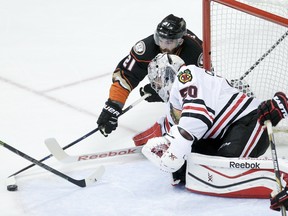 Chicago Blackhawks goalie Corey Crawford, left, blocks a shot by Anaheim Ducks right wing Kyle Palmieri during the first period of Game 2 of the Western Conference final during the NHL hockey Stanley Cup playoffs in Anaheim, Calif., on Tuesday, May 19, 2015. (AP Photo/Jae C. Hong)