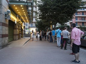 Customers queue to use an ATM outside a Piraeus Bank SA bank branch in Thessaloniki, Greece, on Saturday. Two senior Greek bank executives said as many as 500 of the countryís more than 7,000 ATMs had run out of cash as of Saturday morning. Illustrates GREECE (category f), by James Hertling, Christos Ziotis and Paul Gordon (c) 2015, Bloomberg News. Moved Sunday, June 28, 2015. (MUST CREDIT: Bloomberg News photo by Konstantinos Tsakalidis.)