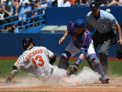 Toronto Blue Jays starting pitcher R.A. Dickey looks to first base after  Baltimore Orioles' Manny Machado singled in the third inning of a baseball  game in Baltimore, Saturday, June 18, 2016. Baltimore