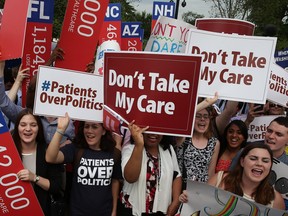 People celebrate in front of the US Supreme Court after ruling was announced on the Affordable Care Act. June 25, 2015 in Washington, DC.