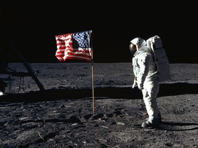 This July 20, 1969 file photo shows US Astronaut Edwin E. Aldrin, Jr., lunar module pilot of the first lunar landing mission, as he poses for a photograph beside the deployed United States flag during Apollo 11 Extravehicular Activity (EVA) on the lunar surface area called the Sea of Tranquility.