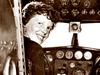 This 1937 photo, provided by The Paragon Agency, shows aviator Amelia Earhart at her Electra plane cabin, taken by Albert Bresnik at Burbank Airport in Burbank, Calif.