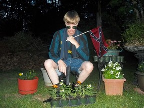 Dylann Roof seen holding a Confederate flag in an undated photo found on LastRhodesian.com, believed to have been his personal website.