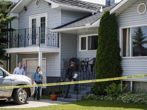Calgary police investigators check out the home where five-year-old Nathan O'Brien and his grandparents Alvin and Kathryn Liknes disappeared, in Calgary, Alta., Wednesday, July 2, 2014.