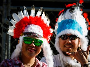 Parade goers wear First Nations headdress during the Calgary Stampede parade in Calgary, July 3, 2015.