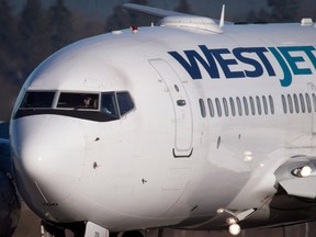 A Westjet Boeing 737-700 plane arrives at Vancouver International Airport in Richmond, B.C., on Monday February 3, 2014.