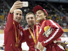 Benoît Huot arranges a selfie with his teammates after they swept the medals in the 400 metre individual medley.