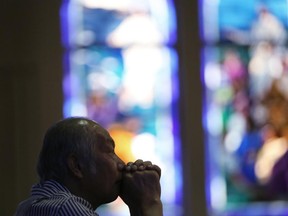 A Catholic offers prayers at an early morning mass.