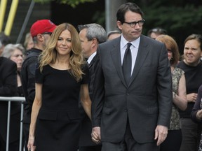 Parti Quebecois leader Pierre Karl Peladeau and his pertner Julie Snyder, left, arrive at Saint-Germain díOutremont Church for the  funeral of former Quebec Premier Jacques Parizeau, Tuesday June 9, 2015.