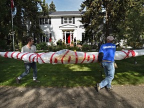 EDMONTON, ALTA: AUGUST 17, 2015 -- Brendan Griebel (L), director of the Inuit Heritage organization and Gordon Baergen removing a historic caribou skin kayak from the basement of this house where it has been stored for nearly 50 years in Edmonton, August 17, 2015. It is being returned to its home in the Nunavut community of Kugluktuk. (ED KAISER/EDMONTON JOURNAL) ORG XMIT: POS1508171727120747