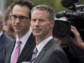 Nigel Wright, former Chief of Staff to Prime Minister Stephen Harper, leaves the courthouse in Ottawa for a break with his lawyer Peter Mantas, left, as he testifies in the trial of former Conservative Senator Mike Duffy.