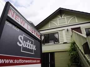 A real estate sign adorns a house for sale in Vancouver.