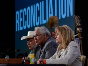 Commission chairman Justice Murray Sinclair, centre, and fellow commissioners Marie Wilson, right, and Wilton Littlechild discuss the commission's report on Canada's residential school system at the Truth and Reconciliation Commission.