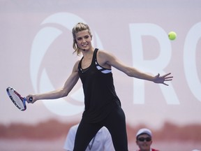 Eugenie Bouchard returns a shot during an exhibition match on a tennis court atop a barge docked on Lake Ontario in Toronto on Wednesday, July 22, 2015. THE CANADIAN PRESS/Aaron Vincent Elkaim