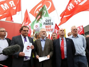 Jeremy Corbyn, candidate for the leadership of the Labour Party, center, stands with members of trade unions at an event outlining his plans for a publicly owned railway network.