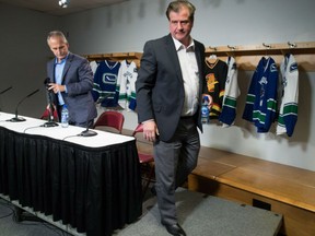 General manager Jim Benning, right, and head coach Willie Desjardins leave the podium after Thursday’s Canucks news conference in Vancouver. The upbeat team insists it’s much better and tougher than most people think.
Photograph by: DARRYL DYCK , THE CANADIAN PRESS