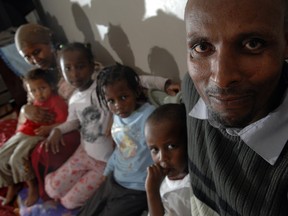 Monday July 6, 2009 Page A1
EDMONTON, AB. JULY 2, 2009 -The Aman family are refugees from Ethiopia who owe the government more than $10,000 for their flights from Ethiopia to Canada. In the foreground is Yusef Mohamed Aman, and his wife and kids from left. Muidheftu Abdo, Soretti,2, Hamda,8, Kanani, 6 and Dhugomsa,4. (SHAUGHN BUTTS/EDMONTON JOURNAL)  Alex Zabjek story