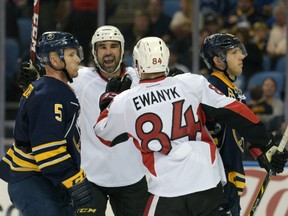 Buffalo Sabres defenseman Chad Ruhwedel, left, and defenseman Matt Donovan react to a goal by Ottawa Senators right winger Zach Stortini, second from right, while center Travis Ewanyk  celebrates during the second period of a preseason game Wednesday in Buffalo. The Senators won 5-2. AP Photo/Gary Wiepert