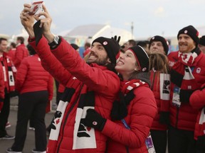 In this 2014 file photo, Charles Hamelin and Marianne St-Gelais take a selfie at the Sochi Olympics.