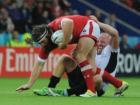 Canada's Hubert Buydens is tackled by Romania's Mihaita Lazar during the Rugby World Cup Pool D match between Canada and Romania at the Leicester City Stadium, Leicester, England, Tuesday, Oct. 6, 2015. (AP Photo/Rui Vieira)