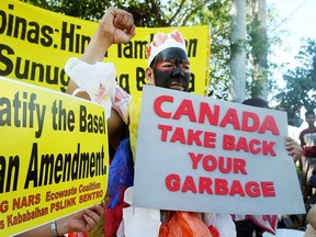 Activists rally outside the Philippine Senate in Manila on Sept. 9, 2015 to demand that garbage containers be shipped back to Canada.