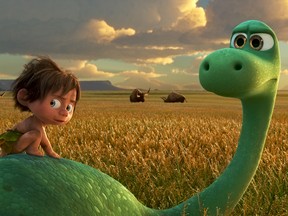 This image released by Pixar-Disney shows Spot, voiced by Jack Bright, left, and Arlo, voiced by Raymond Ochoa, in a scene from "The Good Dinosaur." (Pixar-Disney via AP)