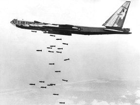 A U.S. Air Force strategic air command B-52 stratofortress drops a string of 750-pound bombs over a coastal target in the Republic of Vietnam during the Vietnam War, Oct. 1965.