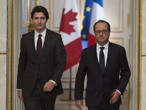 Canadian Prime Minister Justin Trudeau and French President Francois Hollande  enter the room at the Palce Elysee to deliver joint statements, in Paris, France, on Sunday, Nov. 29, 2015. Trudeau is in Paris to attend the United Nations climate change summit. THE CANADIAN PRESS/Adrian Wyld ORG XMIT: POS1511291026564770