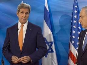 Israel's Prime Minister Benjamin Netanyahu, right, looks on as U.S. Secretary of State John Kerry speaks during a meeting at the Prime Minister's Office, in Jerusalem on Nov. 24, 2015 .