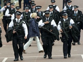Armed Metropolitan Police Service officers take up their positions during the Queens Diamond Jubilee in London, June 2012.