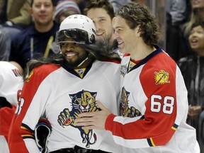 Montreal Canadiens defenceman P. K. Subban, left, wearing a wig and a Jaromir Jagr jersey, is congratulated by the Panthers forward after Subban competed in the breakaway challenge at the NHL All-Star Game skills competition Saturday in Nashville.