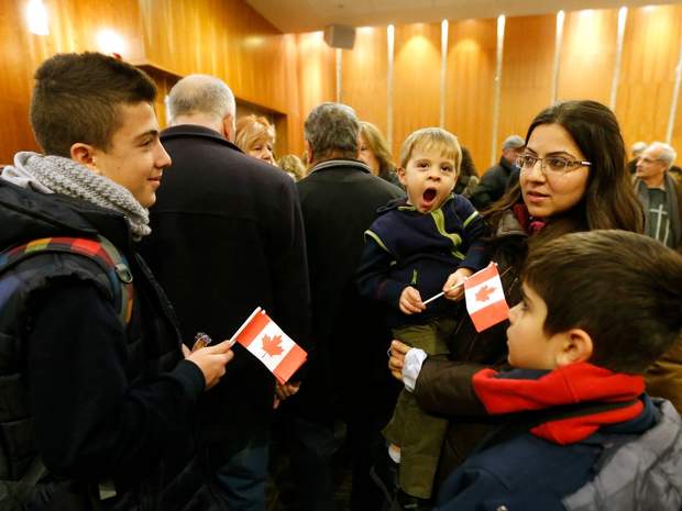 Zawenawedian Dawdian, 2, is held by his mother Mario and was one of a group of sponsored Syrian refugees who arrived in Toronto yesterday and gathered at the Armenian Cultural Centre where they were paired up with their sponsored families on Wednesday December 16, 2015. 