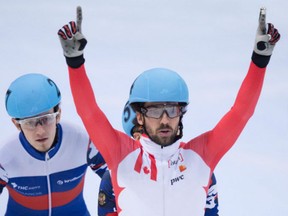 In this Feb. 7, 2016 file photo, Canada's Charles Hamelin (right) celebrates while crossing the finish line to win the men's 500-metre final at a World Cup short-track event in Germany.