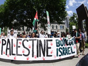 Hundreds of people rally in support of Palestine at the Human Rights Memorial in Ottawa, Saturday, July 12, 2014.