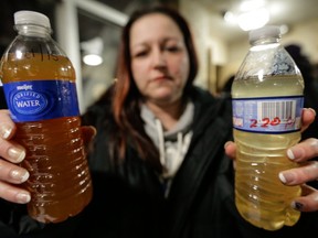 LeeAnne Walters of Flint, Mich., shows water samples from her home from January 21, 2015 and January 15, 2015 in a file photo.