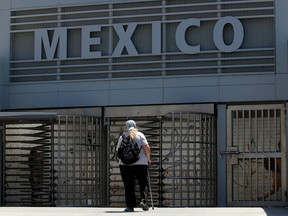 A woman approaches the entrance to the Mexico border crossing in San Ysidro, California.